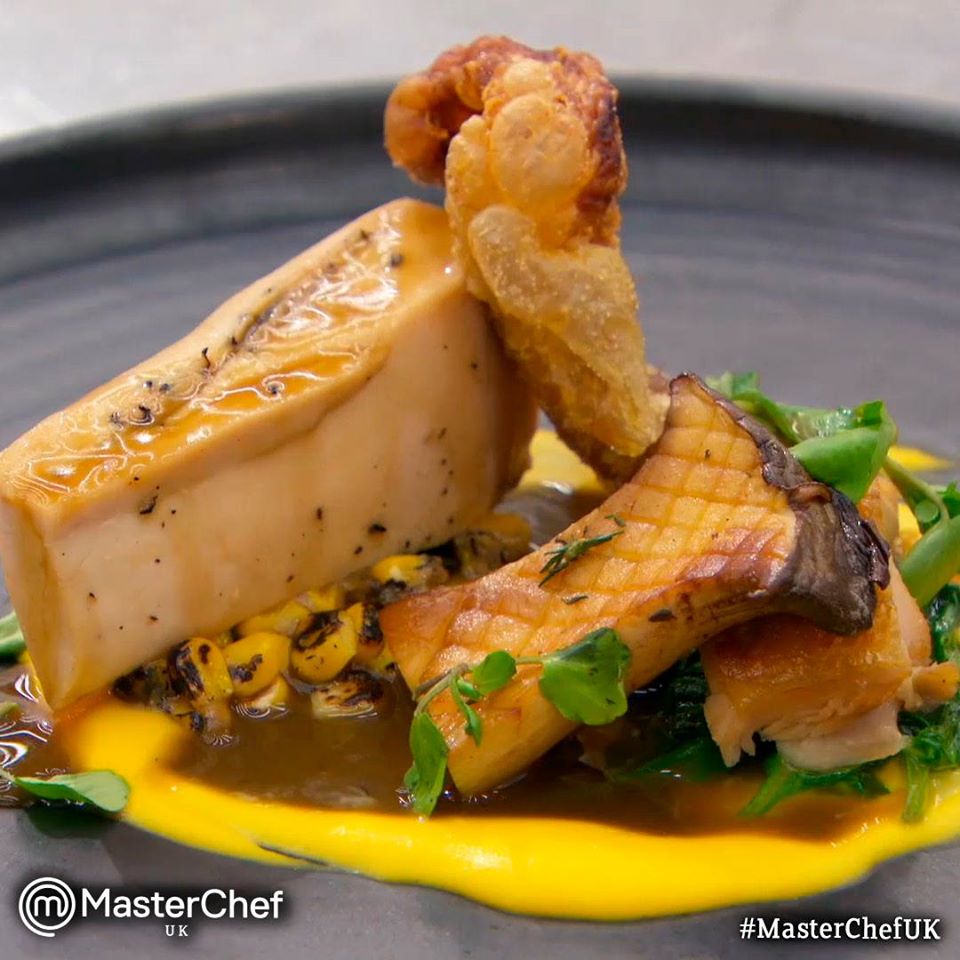 Dish prepared at MasterChef UK. A juicy piece of chicken, with crunchy skin. Mushrooms, corn and greens. A yellow and a brown sauce. Beautifully plated. 